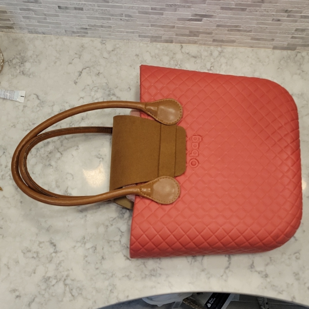 Red Obag with suede strap and handles. INCLUDES floral wristlet